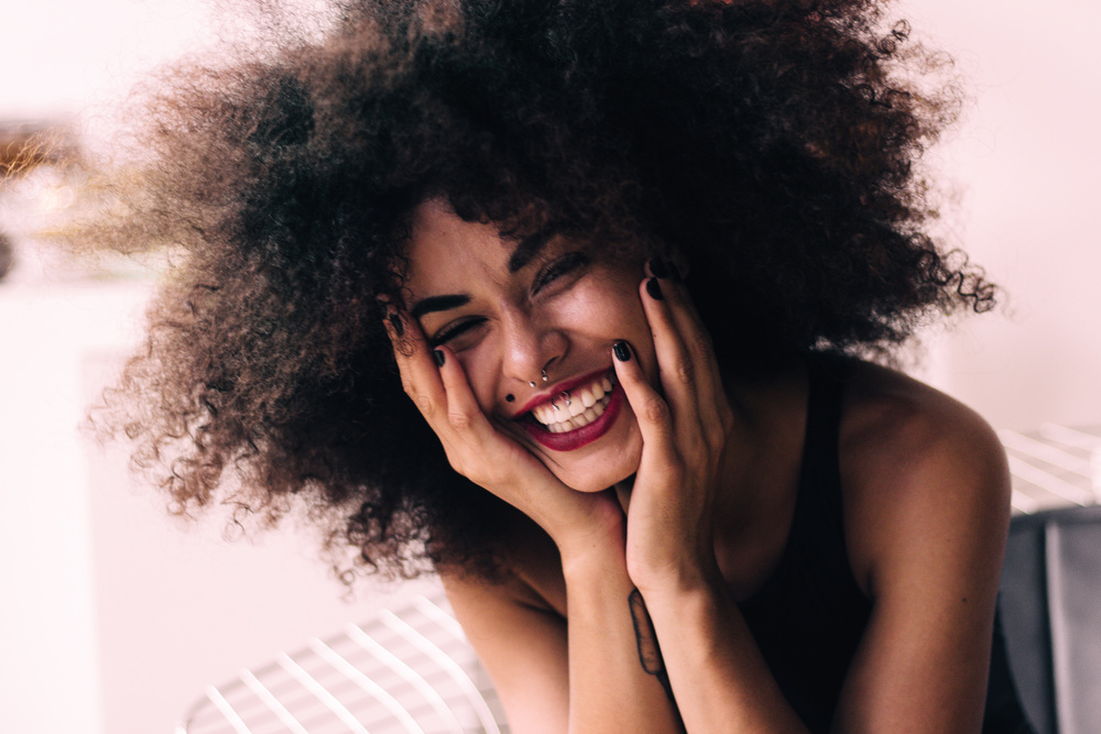 Photo of Smiling Woman with Hands on Her Chick